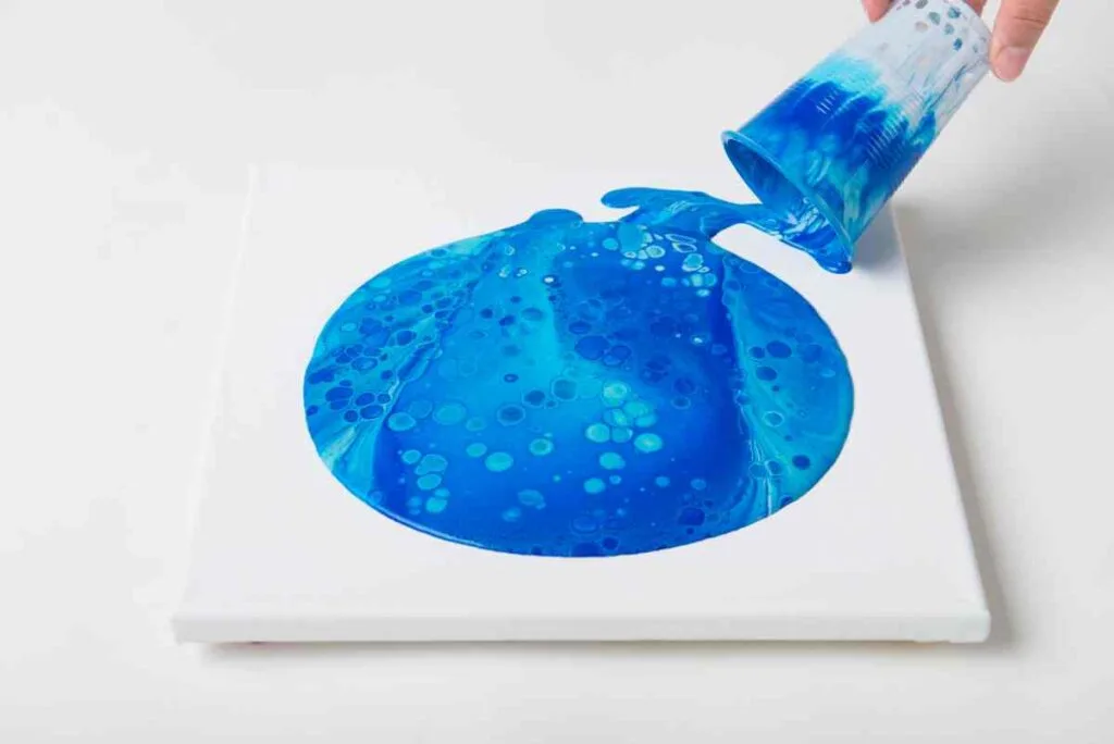 Paint pouring dirty pour technique in blues with silicone oil