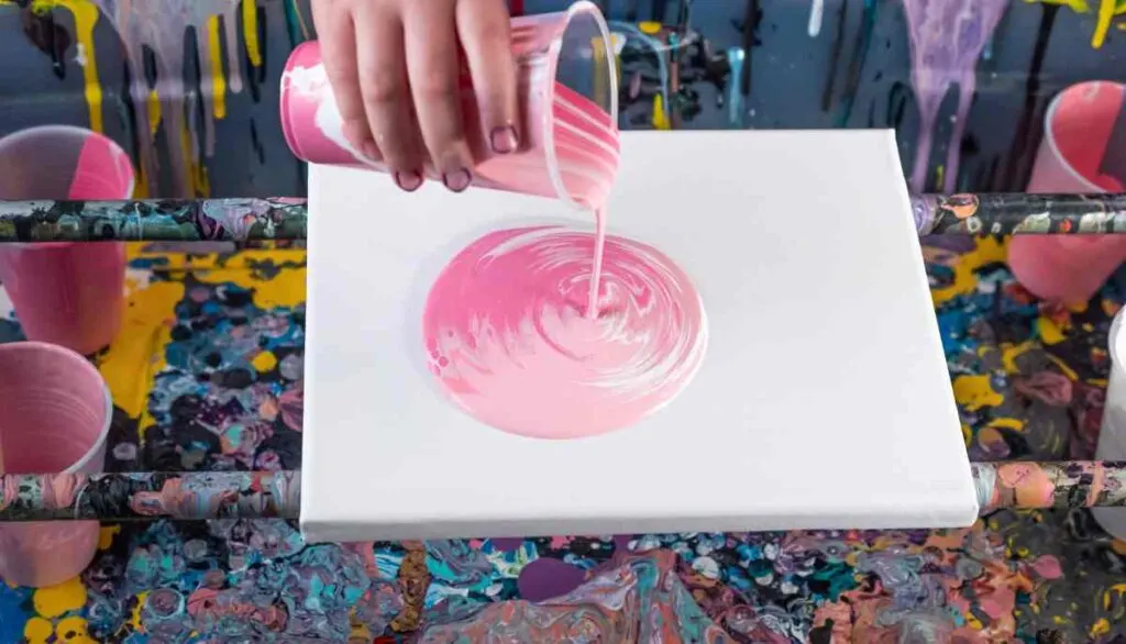 Acrylic paint pouring with shades of pink paint