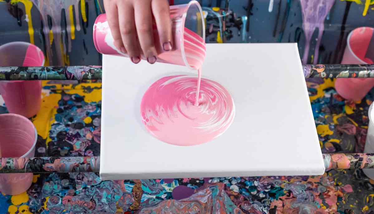 Acrylic paint pouring with shades of pink paint