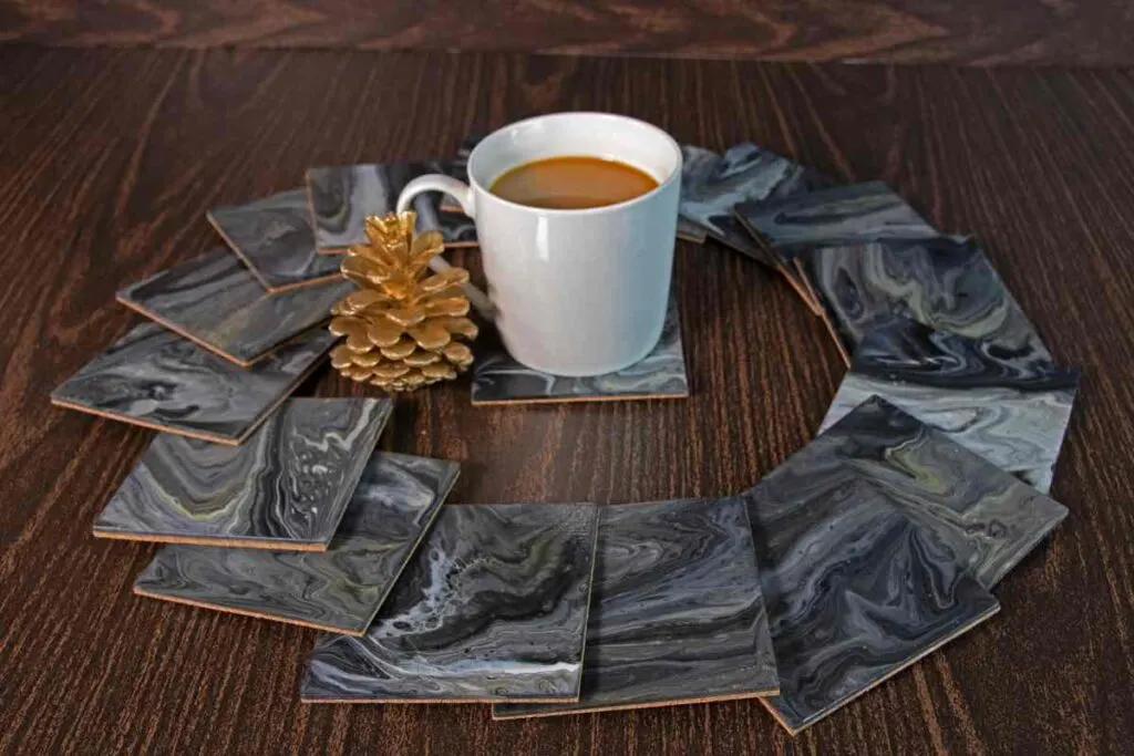 Coffee cup with drink coasters using pouring technique for painted coasters