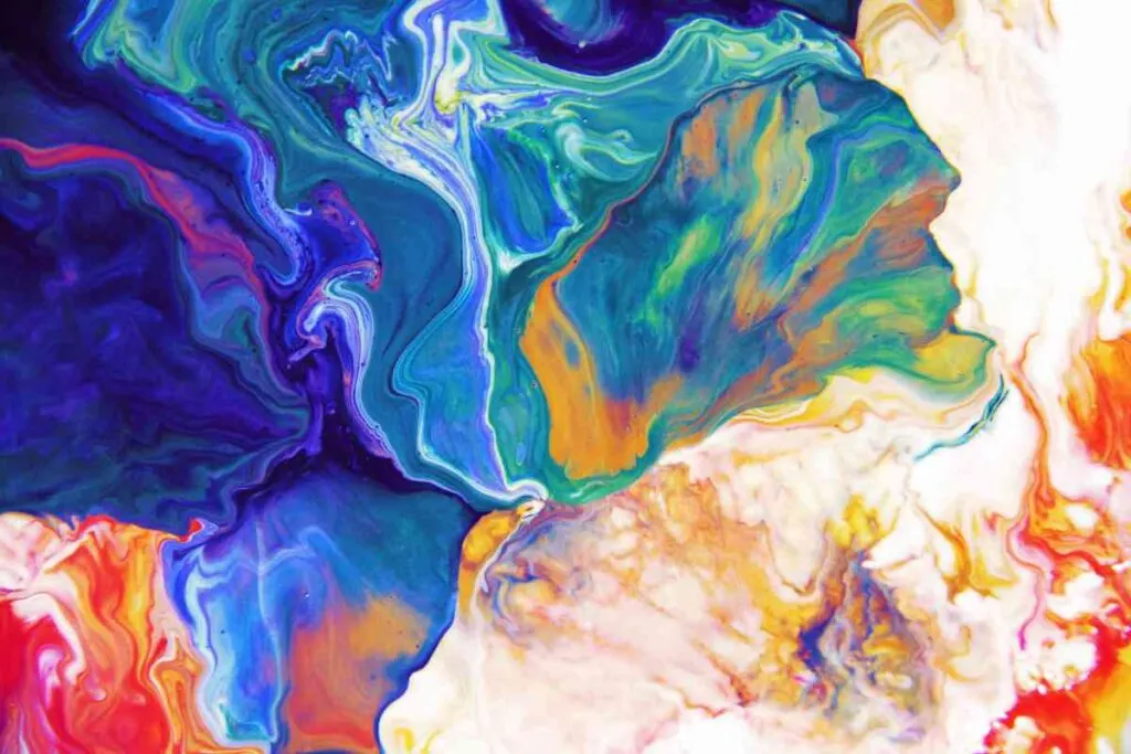 Paint pouring technique in blues, purples, golds, and white