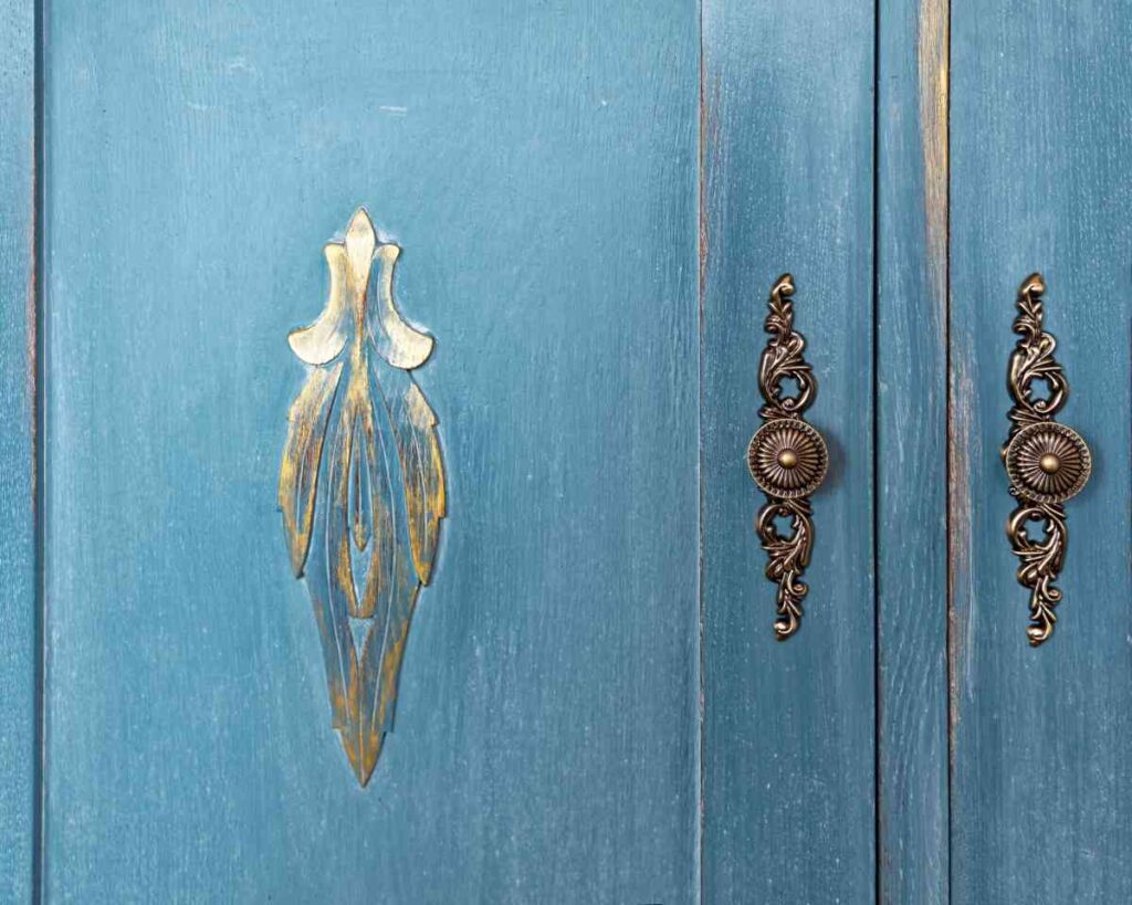 Blue distressed cabinet doors with gold accents
