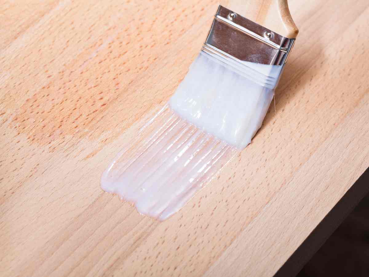 Close up of paintbrush painting veneer furniture