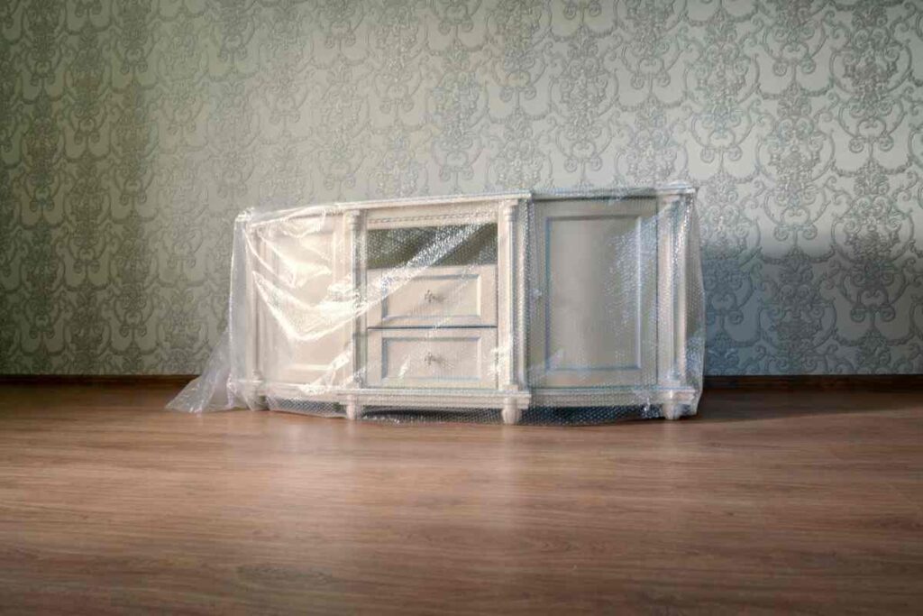 Piece of furniture wrapped in plastic and ready to be shipped