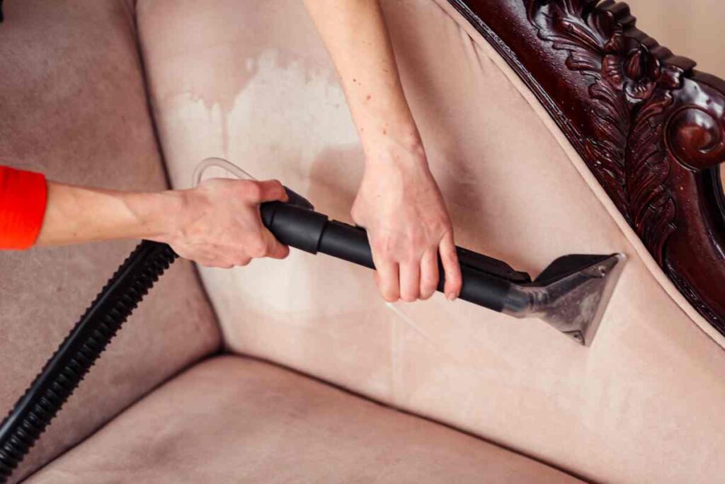 Using a vacuum to clean upholstered furniture