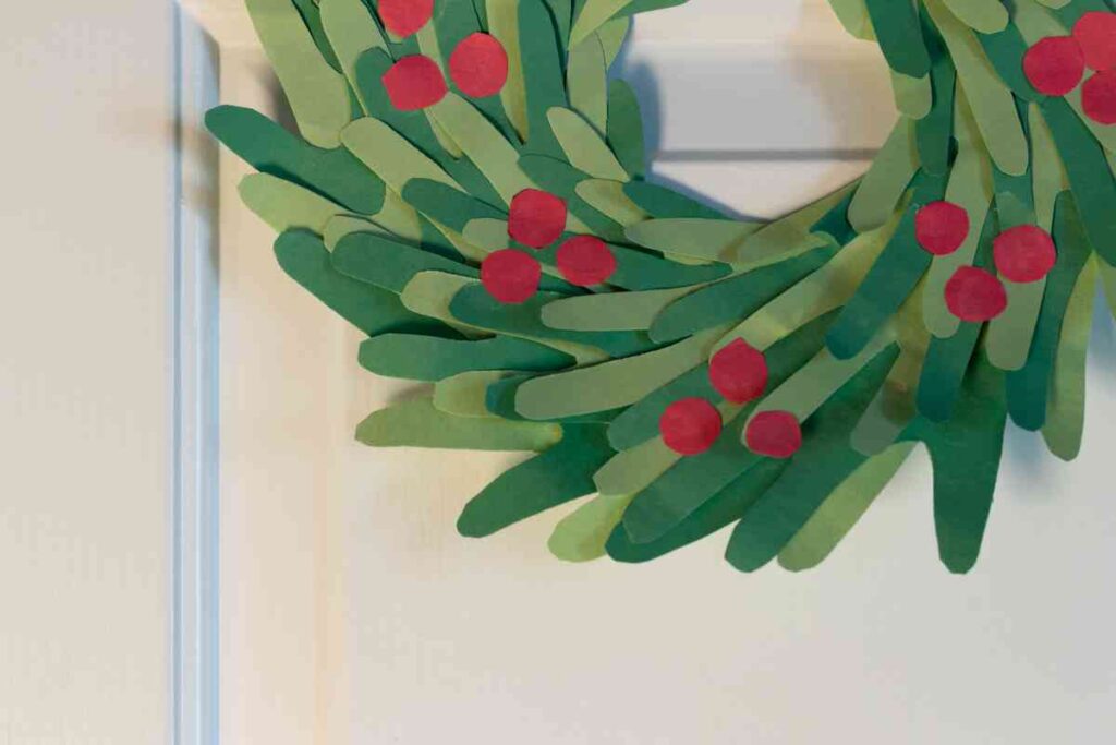 Handprint wreath made out of shades of green construction paper