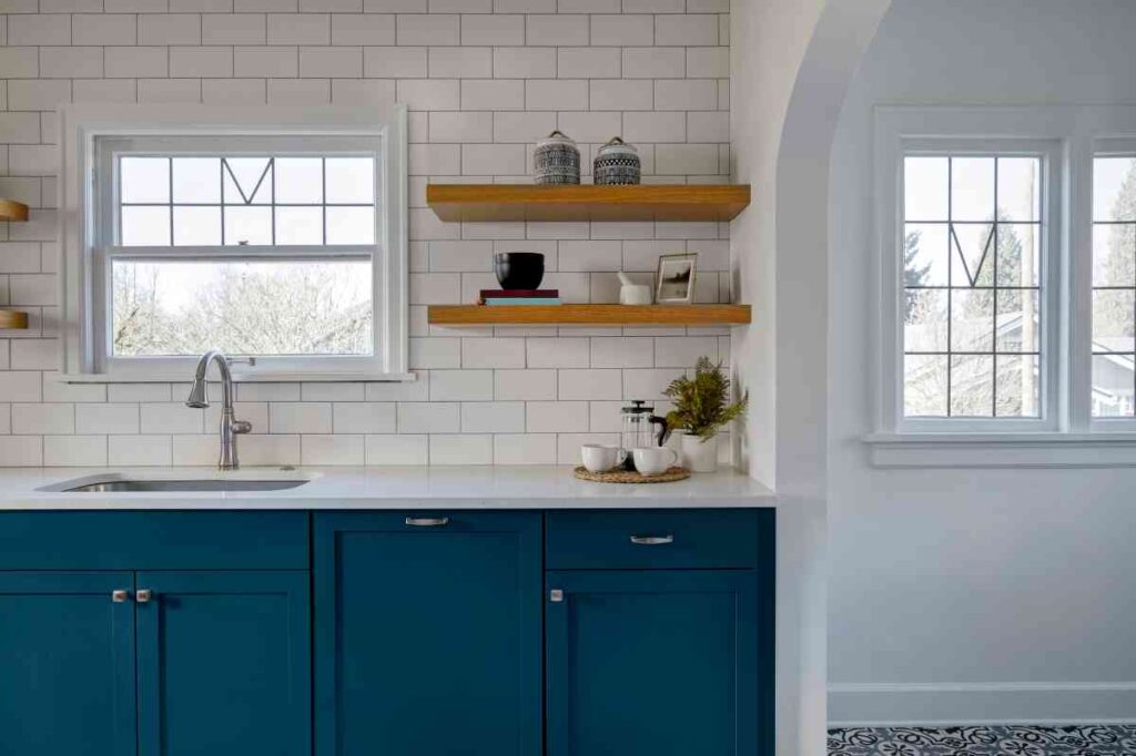 White tile kitchen with cabinets painted blue using the best paint for kitchen cabinets