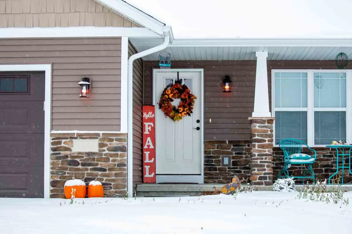 A standing fall sign and wreath show front porch decorating ideas
