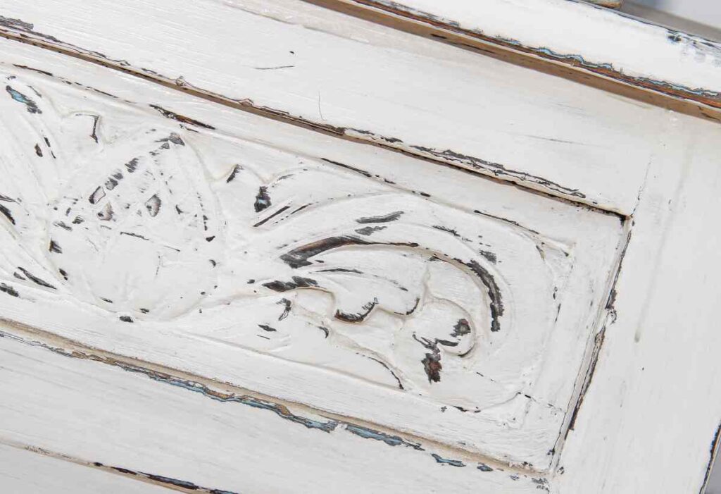 White chest with distressed drawers using wax for furniture distressing