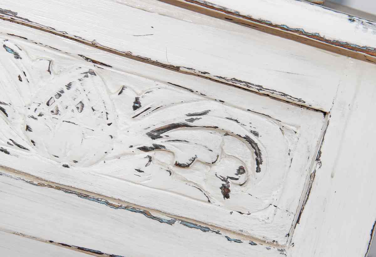 White chest with distressed drawers using wax for furniture distressing