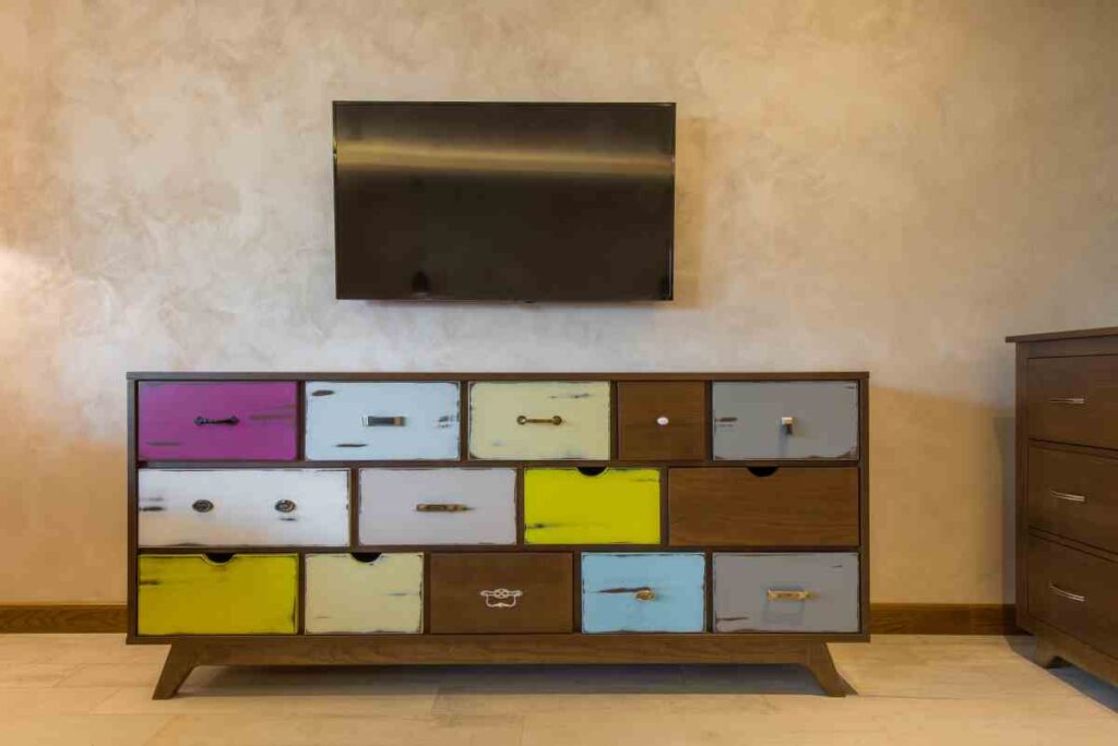 Large vintage dresser with colorful drawers painted with dry brushing technique