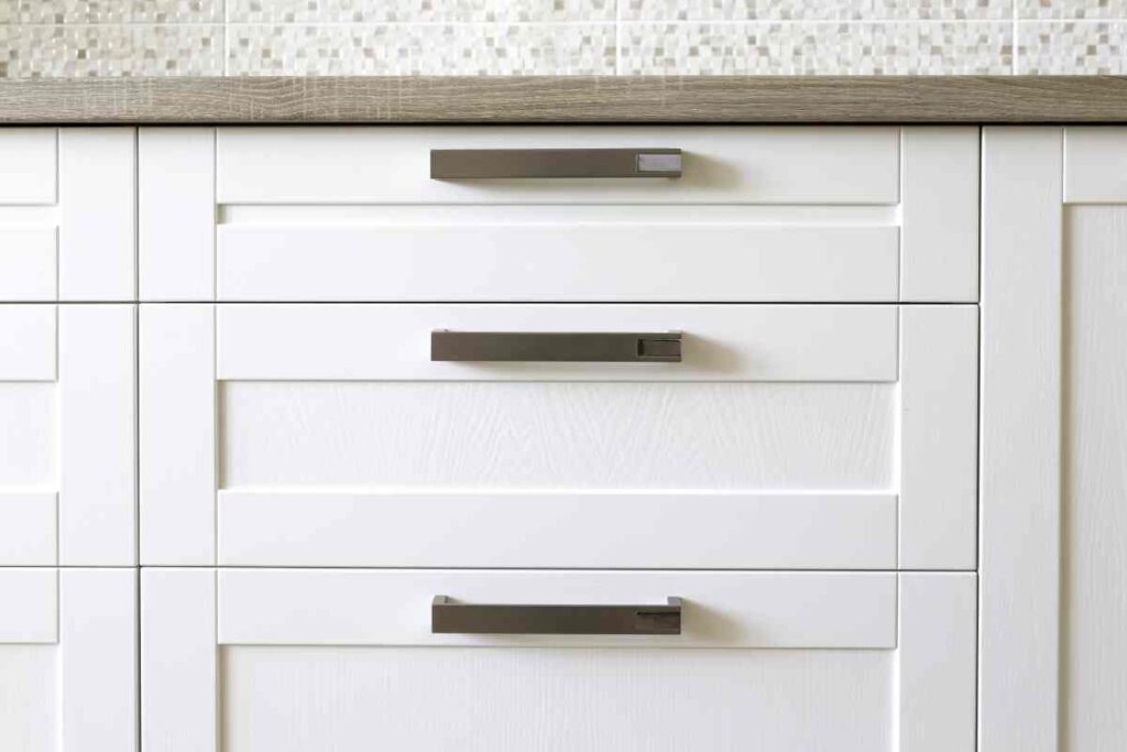 Veneer kitchen cabinets painted white with black hardware