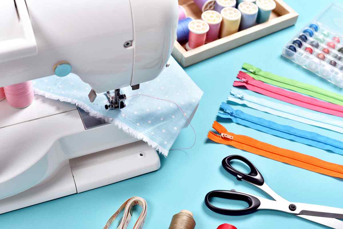 Sewing machine with blue polka dot fabric and pastel zippers and threads. Best sewing machine for beginners