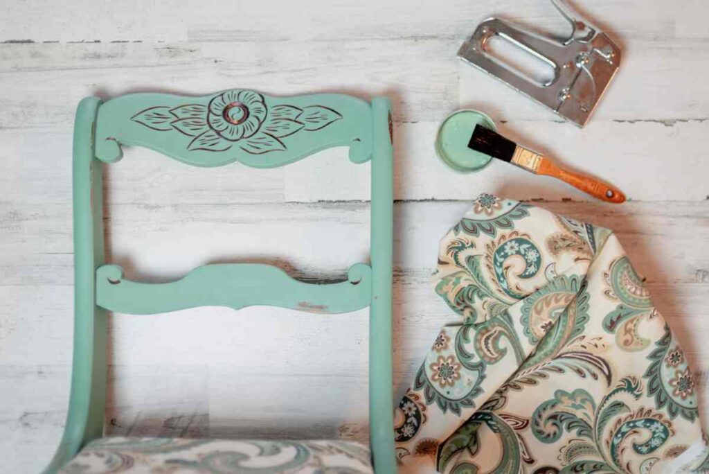 An old chair gets updated with a new coat of teal paint and floral fabric