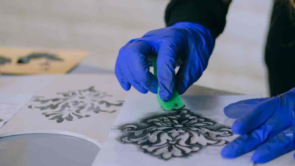 Using a sponge to paint a stencil
