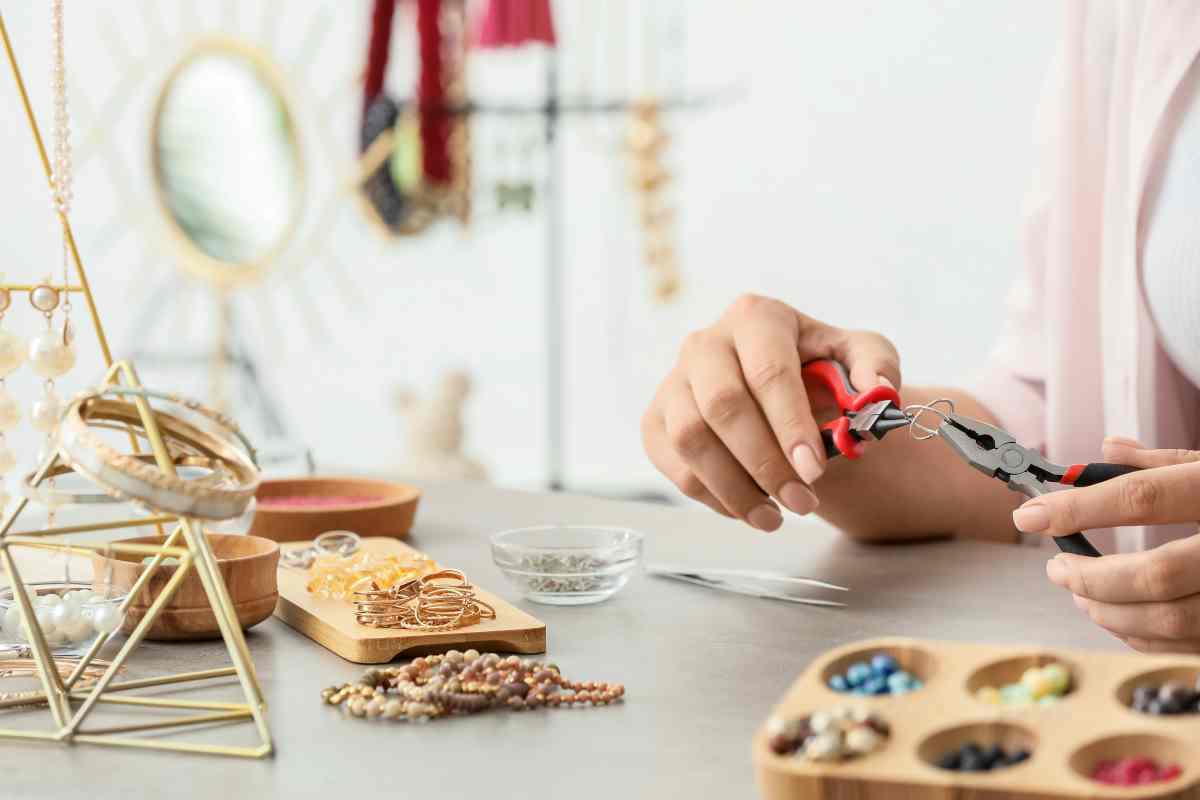 Woman using tools for beading jewelry at the best craft table with storage