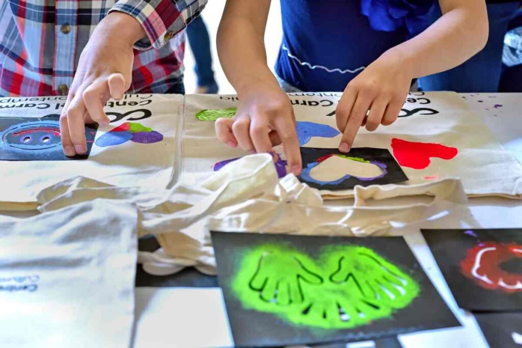 Using craft stencils and fabric paint to decorate canvas bags