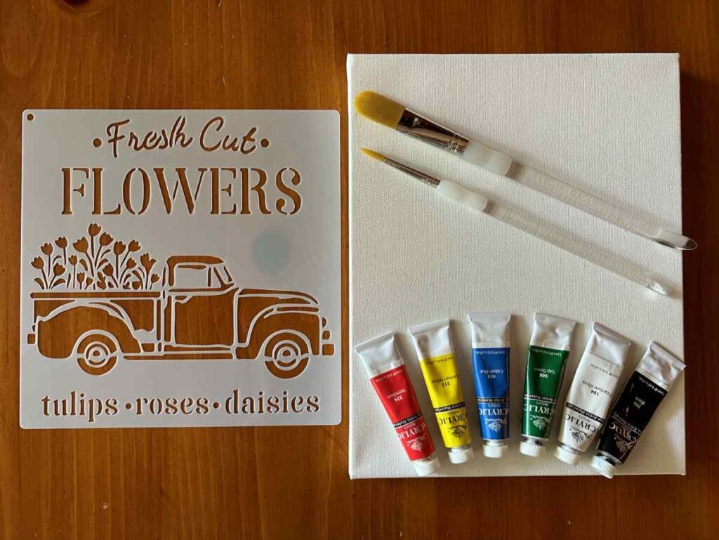 Canvas, paints, paintbrushes, and a stencil.  Items needed to stencil on canvas