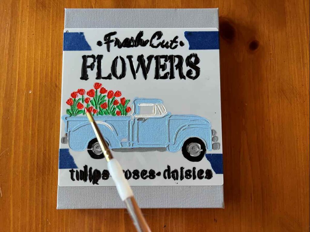 Painting a stencil of a truck on canvas