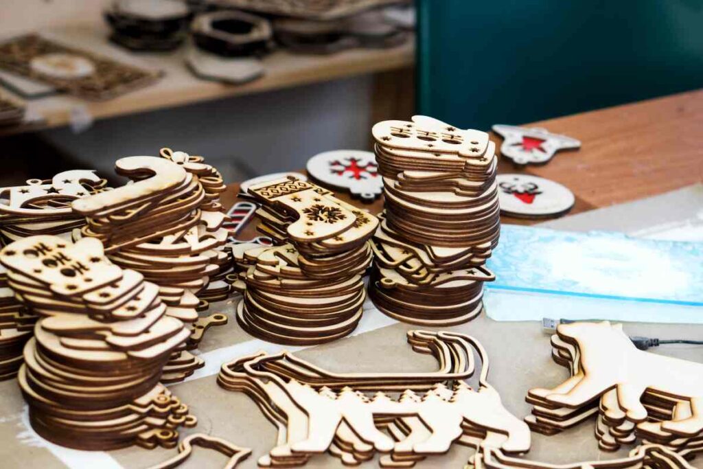 A table with stacks of wooden Christmas ornaments