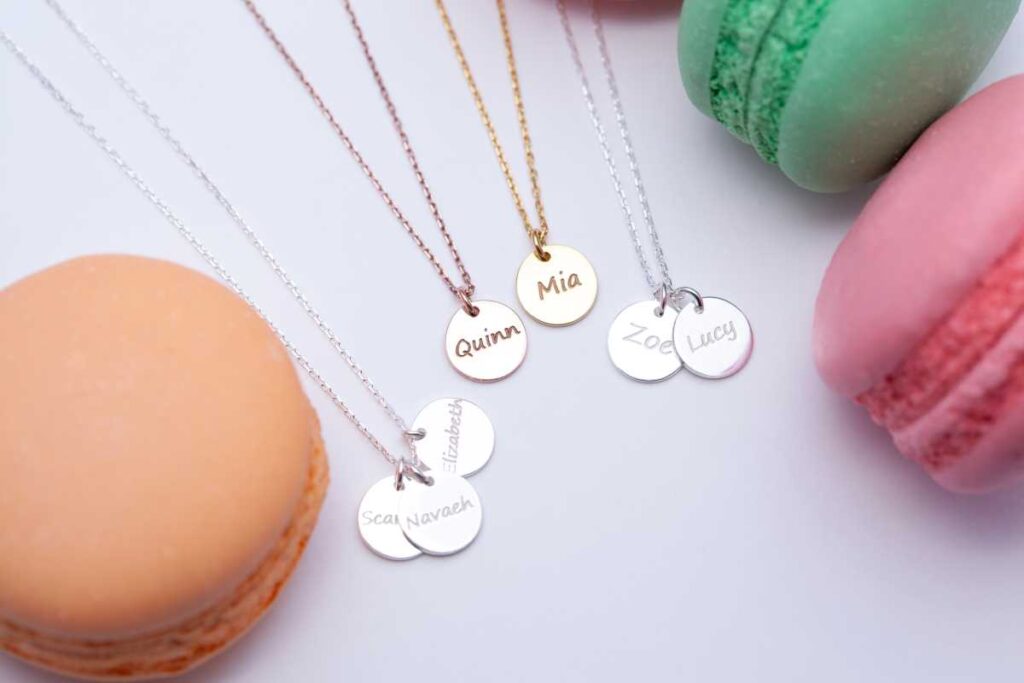 Metal necklaces with names stamped on them