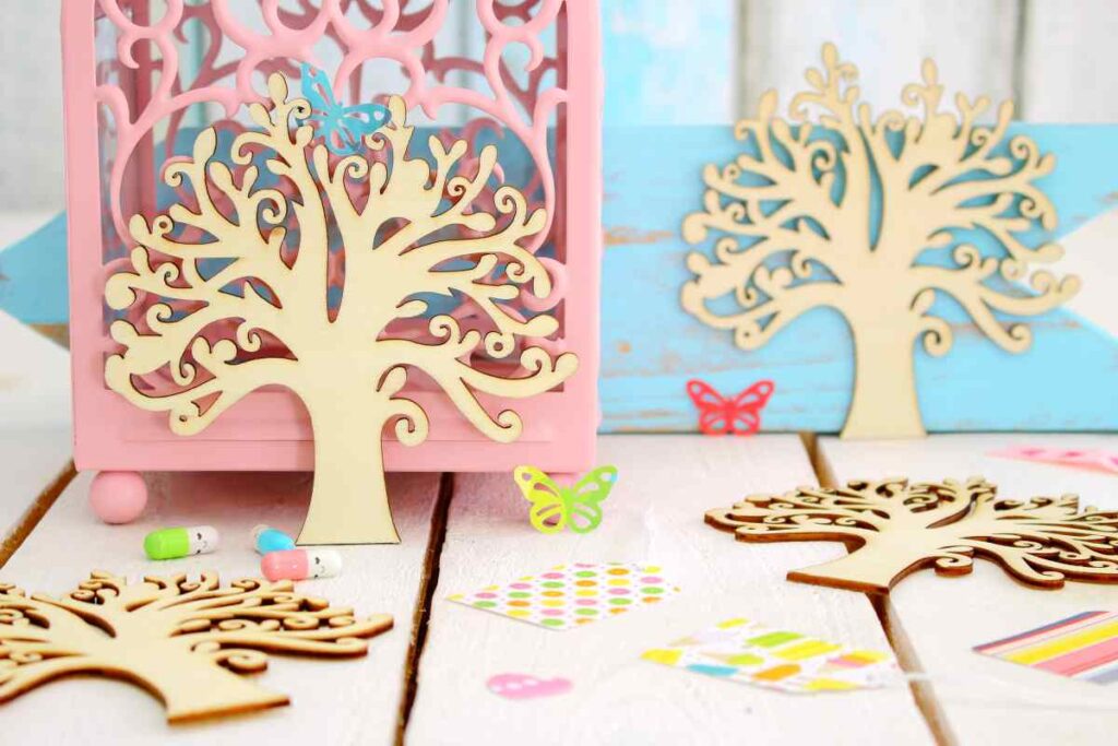 Wooden tree, butterfly, and other craft embellishments made using a wood craft cutting machine