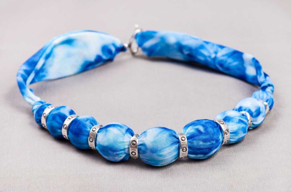 Fabric jewelry necklace in blue with silver accents