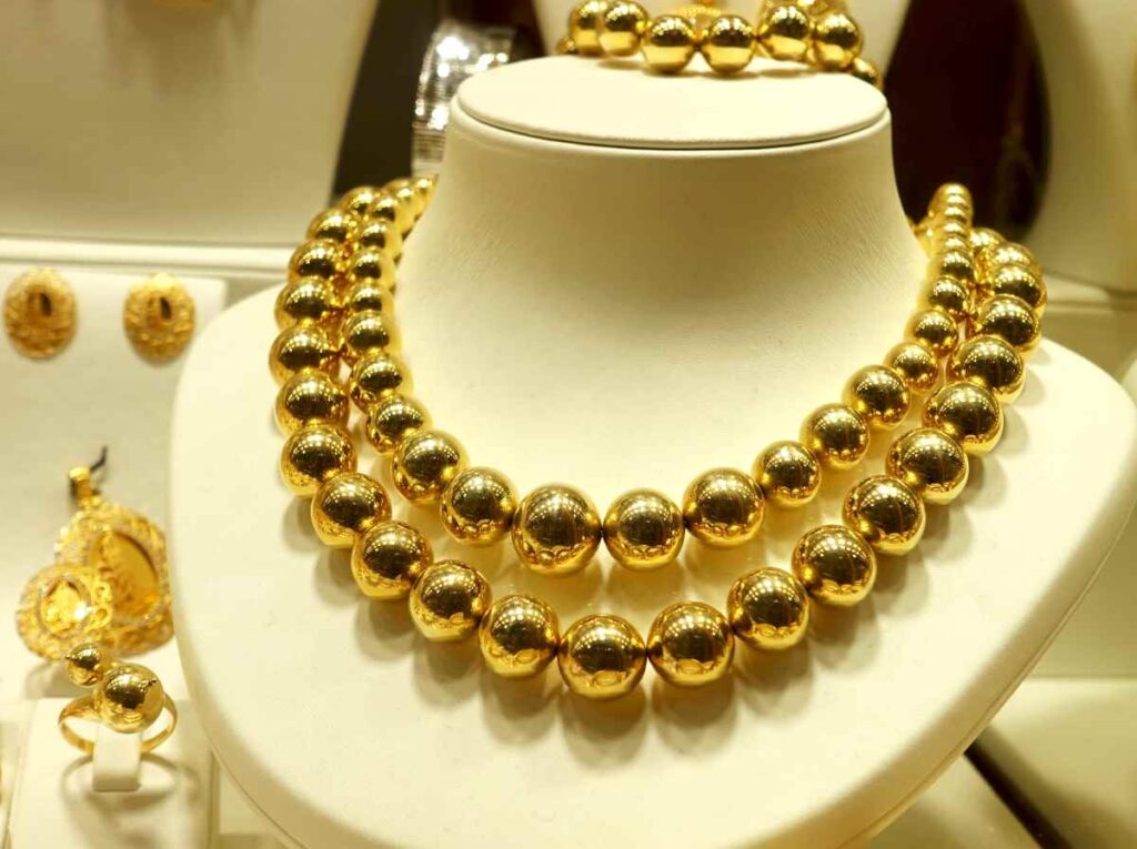 Bust with gold bead necklaces and bracelet