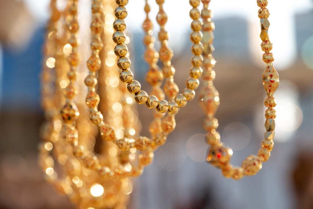 Several styles of necklaces using gold beads for jewelry making