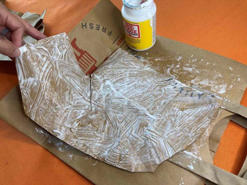 A brown paper bag painted with Mod Podge