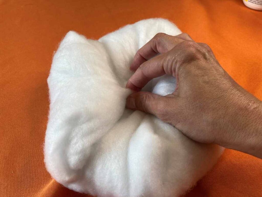 Using straight pins to hold a ball of batting together