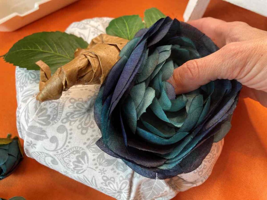 Adding flowers to a fabric pumpkin