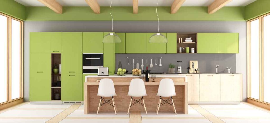 Modern kitchen with bright green cabinets, wood accents, and white chairs