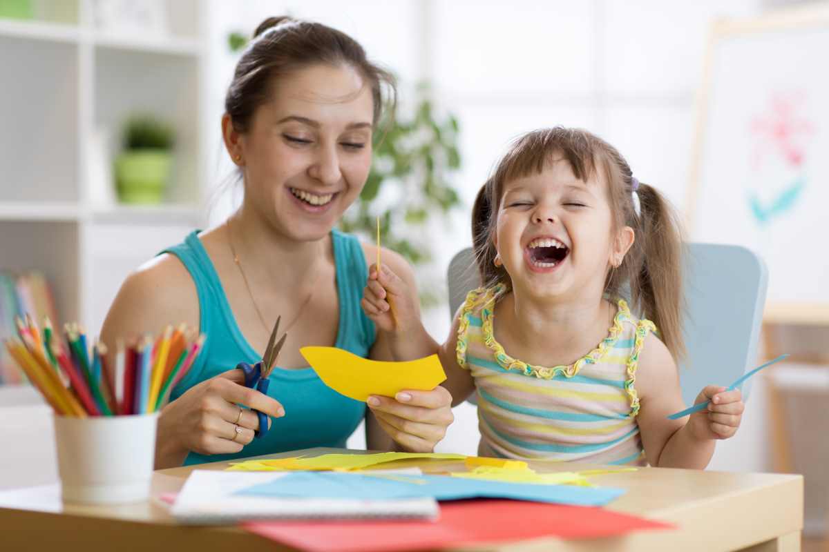 Mom and preschool girl doing crafts together