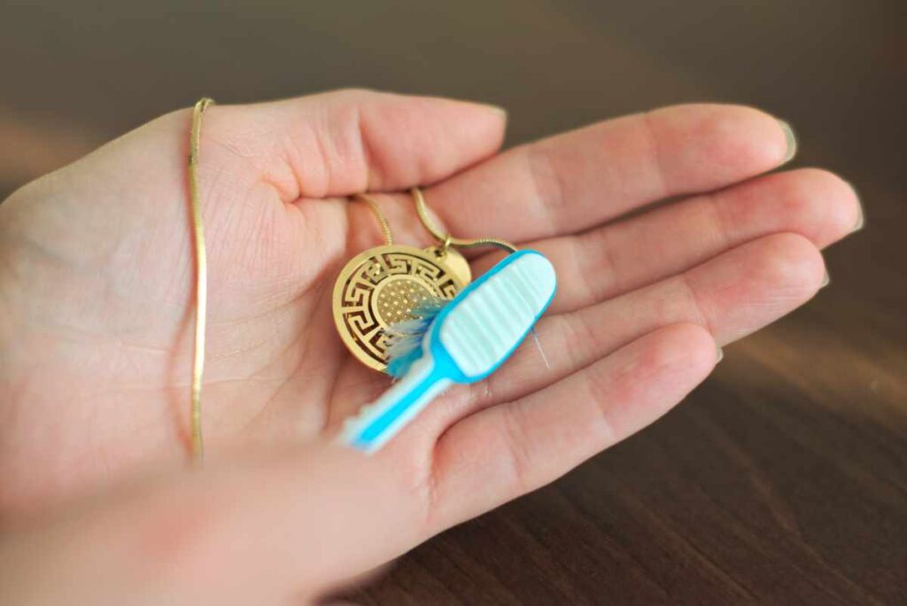 Cleaning a gold plated necklace with a soft toothbrush