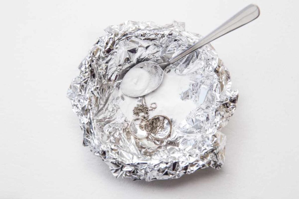 Using a solution of baking soda, salt, and lemon juice to clean tarnished furniture