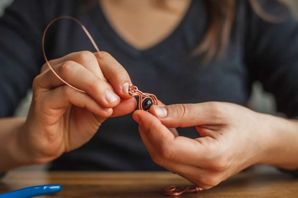Woman making wire wrapped jewelry
