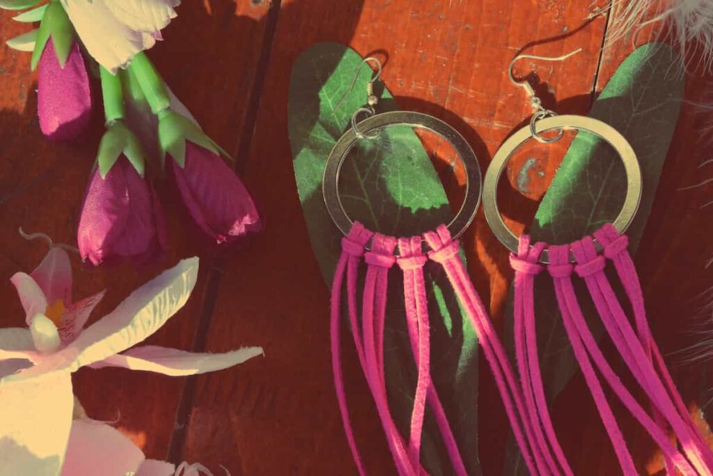 A pair of earrings with pink leather tassels. How to make leather earrings.