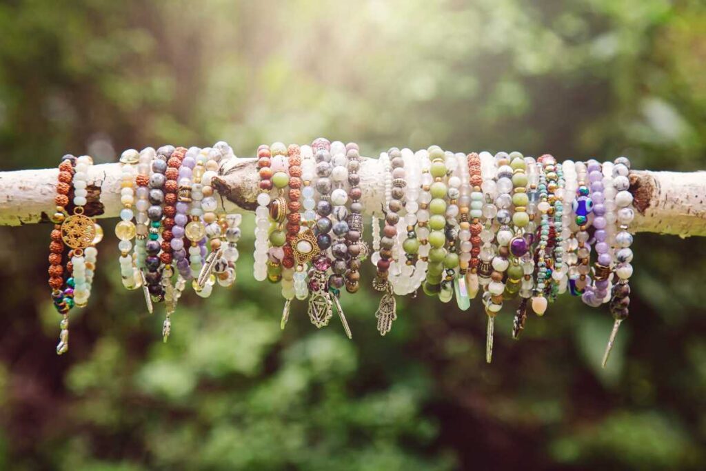 Several styles of beaded charm bracelets on display