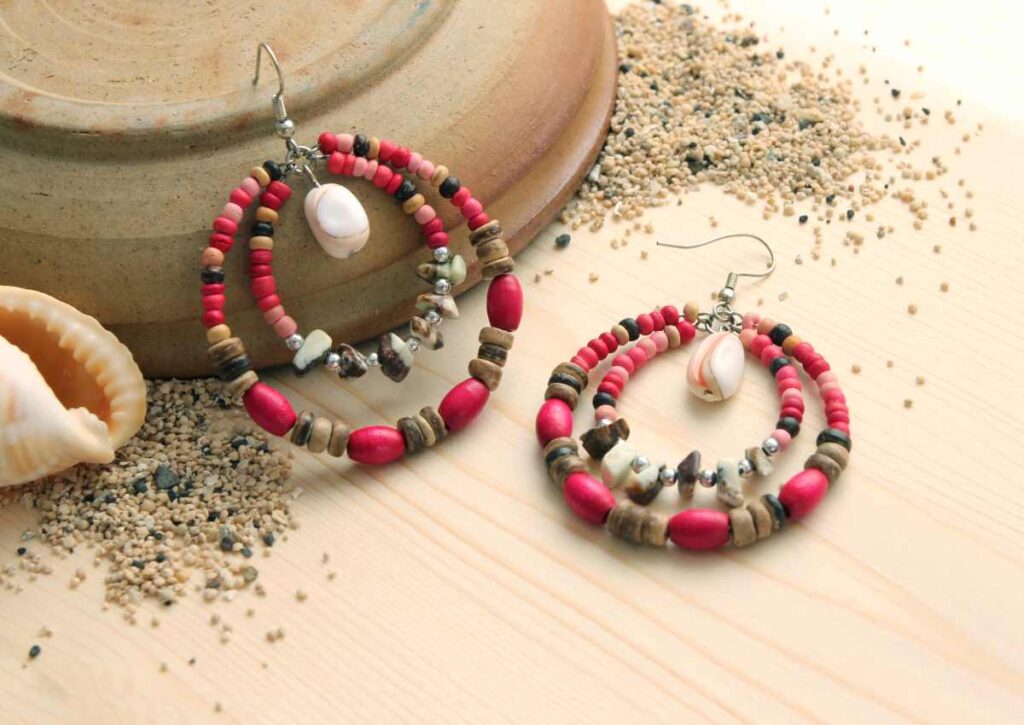 A pair of beaded hoop earrings in earthy colors
