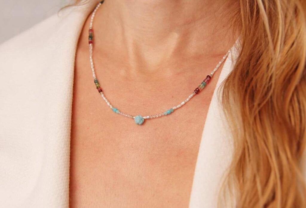 Woman wearing a simple beaded necklace