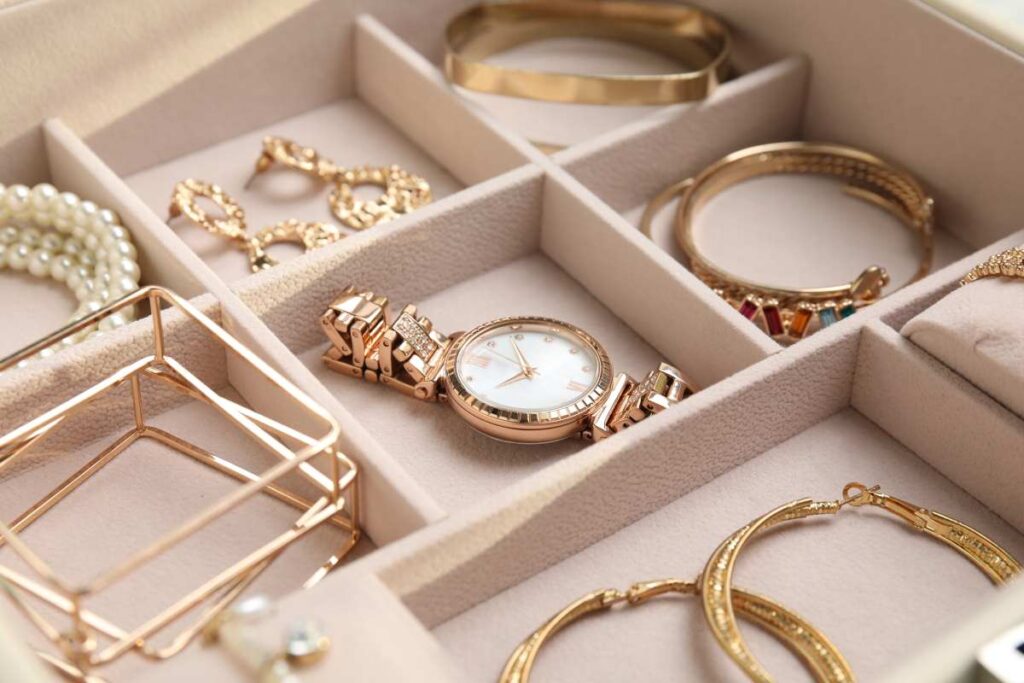 A jewelry box with compartments filled with jewelry