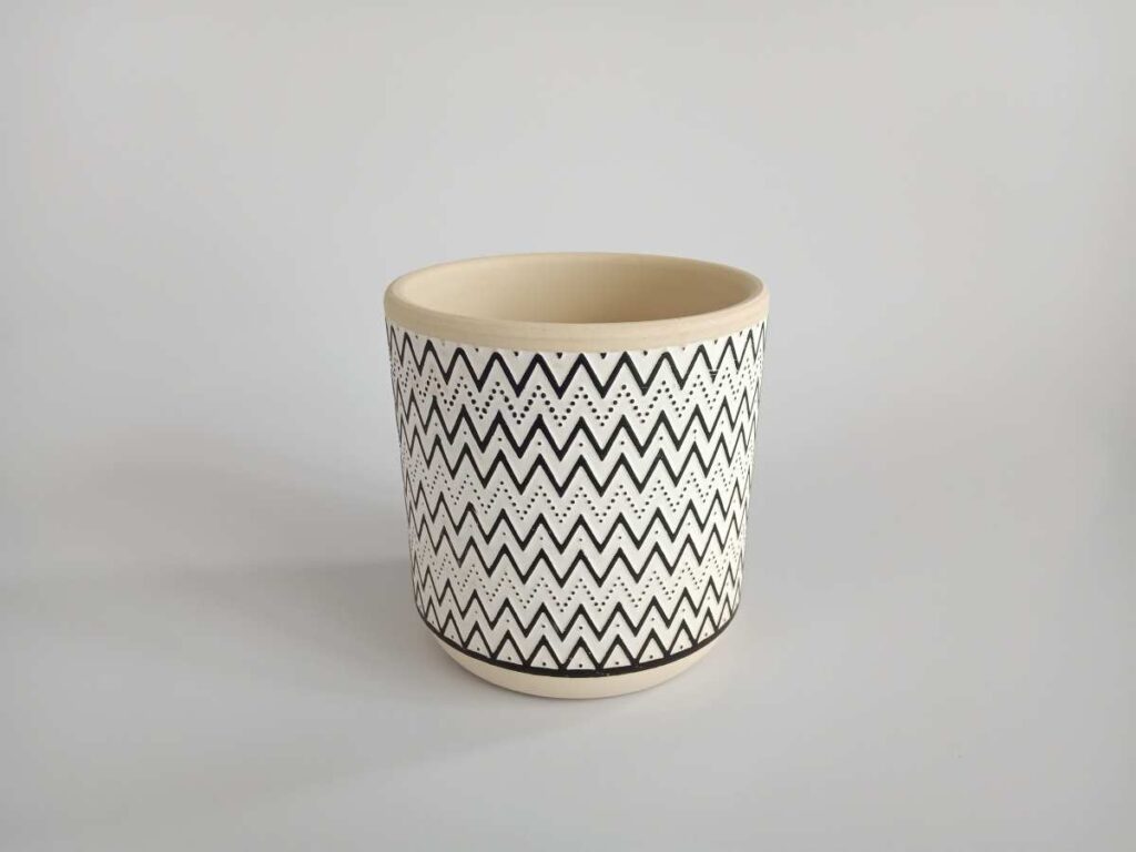Pottery cup designed with dots and zig zags