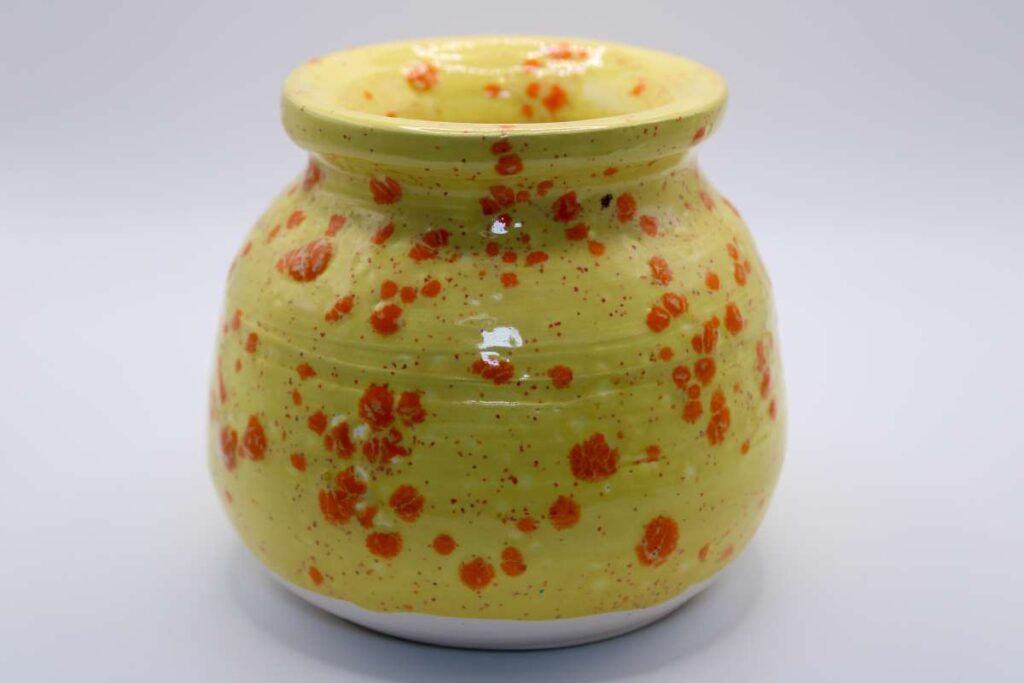 Yellow vase with orange splatter glaze design