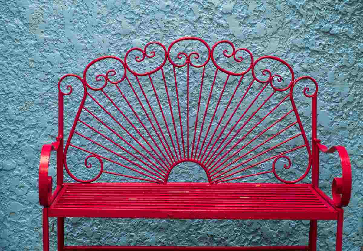A vintage metal chair painted red with the best paint for outdoor metal furniture