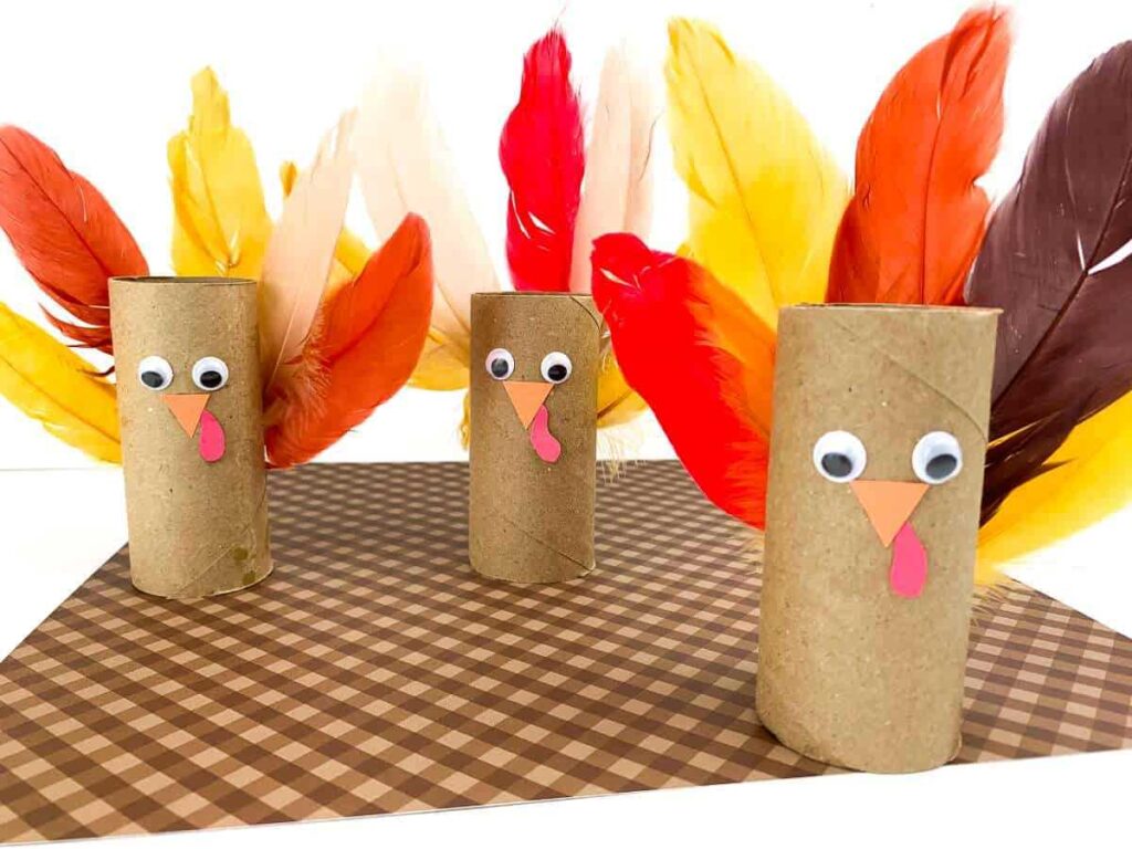 Thanksgiving turkeys made out of toilet paper rolls, feathers, and googly eyes