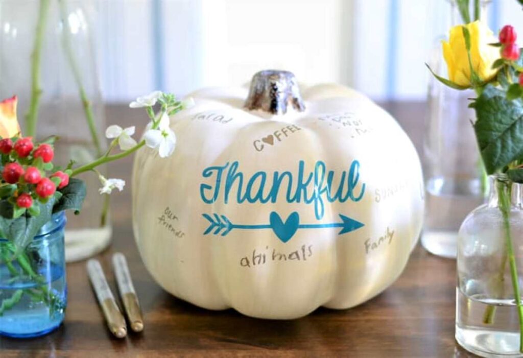 White pumpkin centerpiece with the word Thankful in teal
