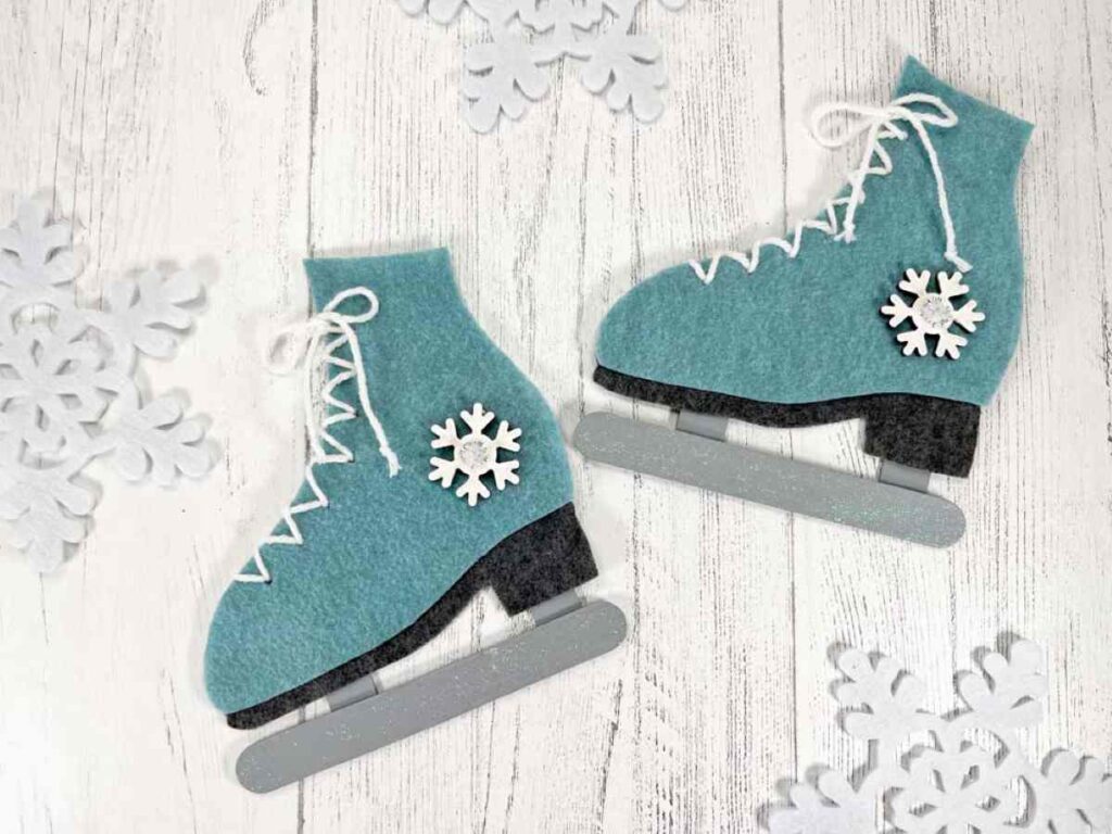 A pair of teal colored felt ice skate ornaments