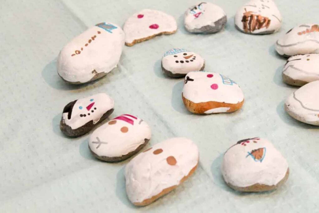 Stones painted to look like snowmen