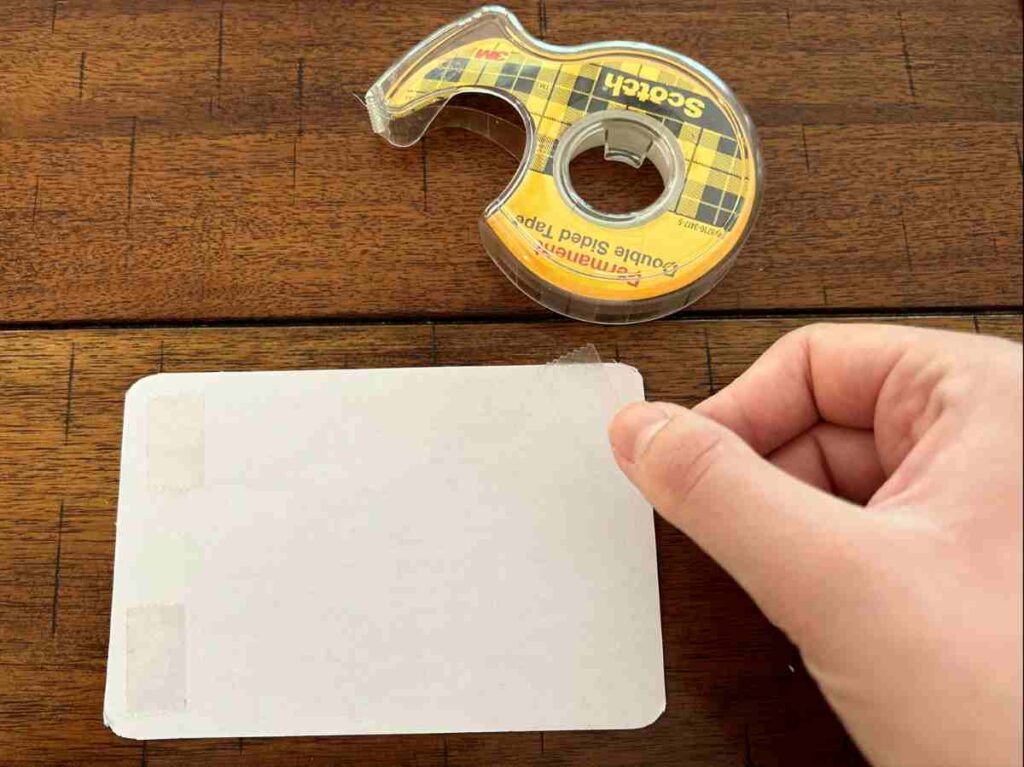 Using double sided tape on a scrapbooking project